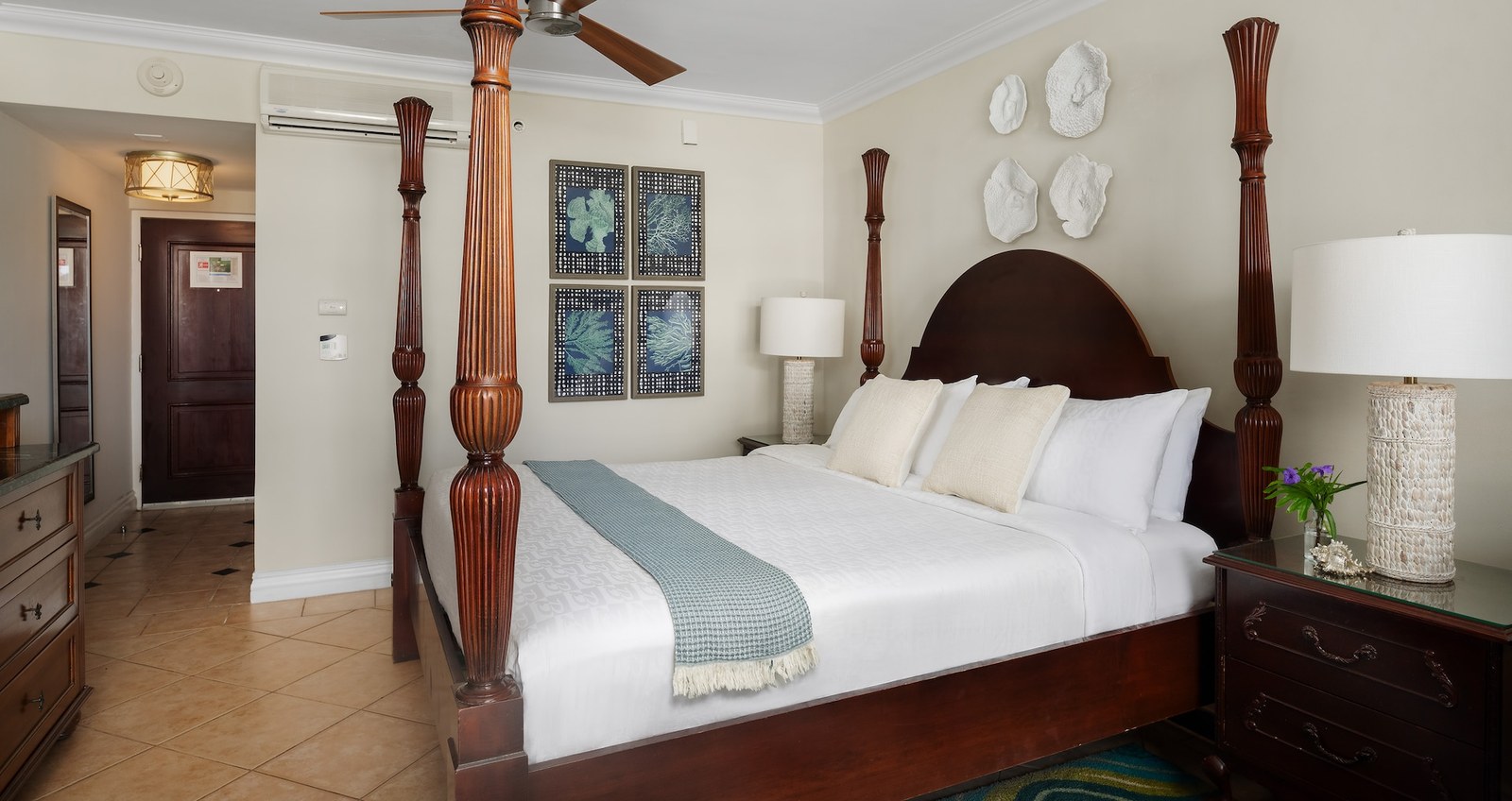 A four-poster king bed in a French Village Luxury Room King at Beaches Turks and Caicos.